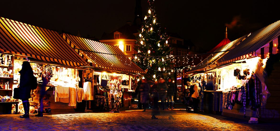 lighted Christmas tree surrounded by houses