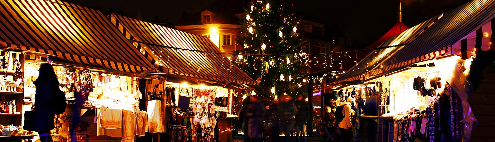 lighted Christmas tree surrounded by houses